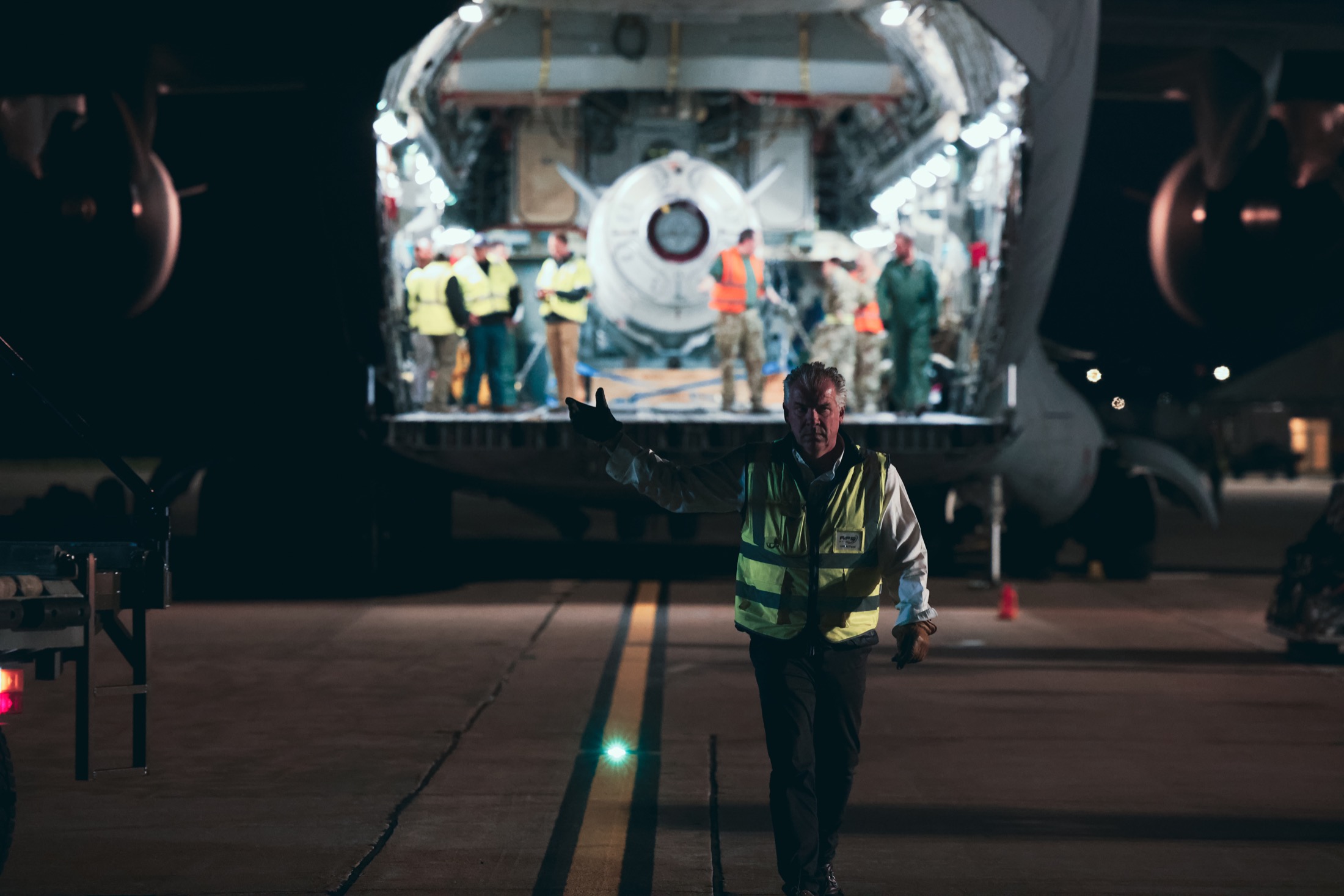Night field operations around Cosmic Girl, LauncherOne, and ground support equipment.