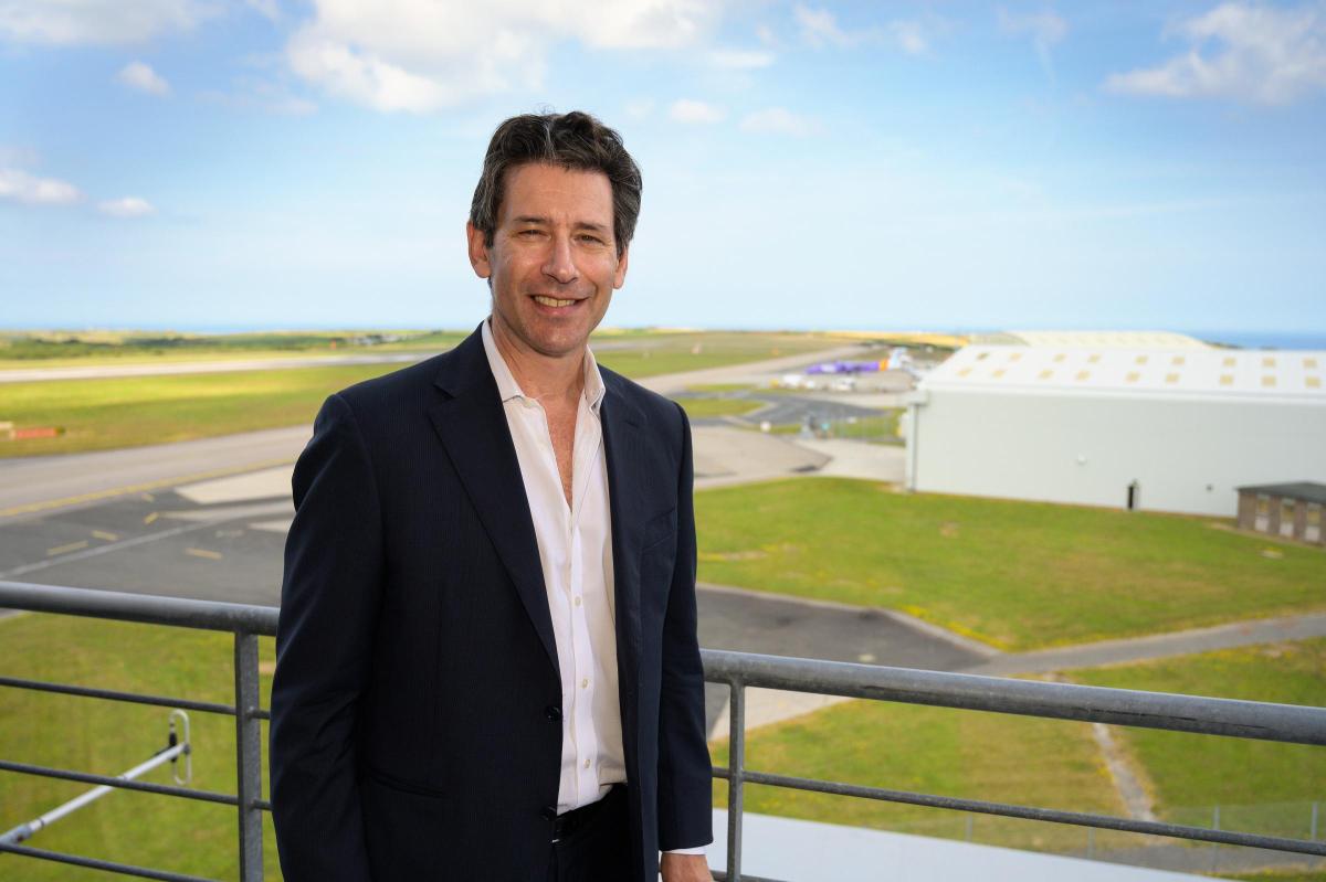 Dan Hart standing beside an airfield.