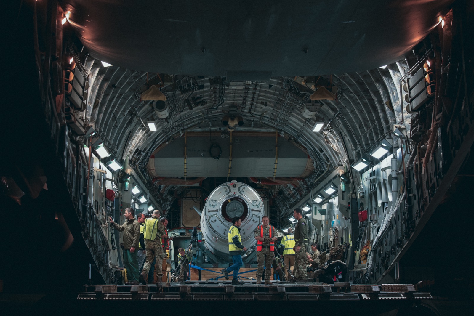Rocket in the foreground inside an aircraft field production environment.